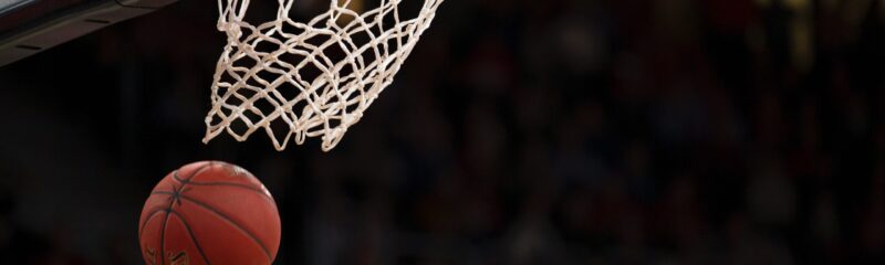 Basketball going through the hoop net.